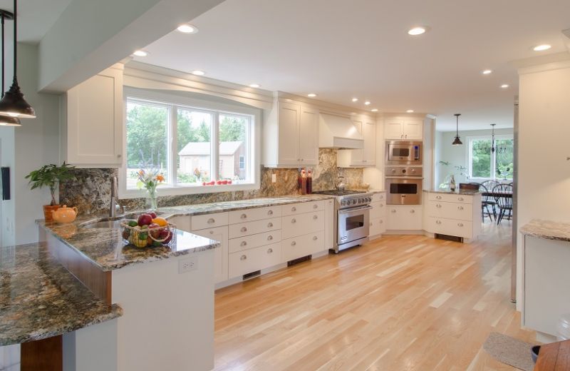 Look how bright this kitchen is! White cabinets maximise natural light while providing a clean design.