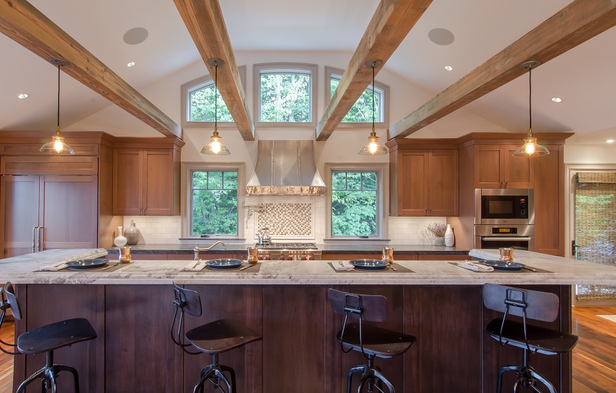 Bold clean lines with dark wood tones accent the unique rafters in this kitchen.