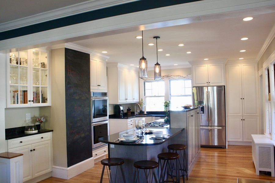 This kitchen feels anything BUT medium. Peninsula that seats 4, a chalkboard and glass cabinets transform this kitchen!