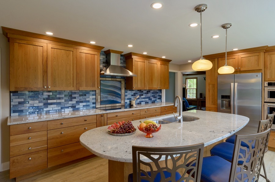 A blue mosiac backsplash is the center piece of this cherry kitchen.