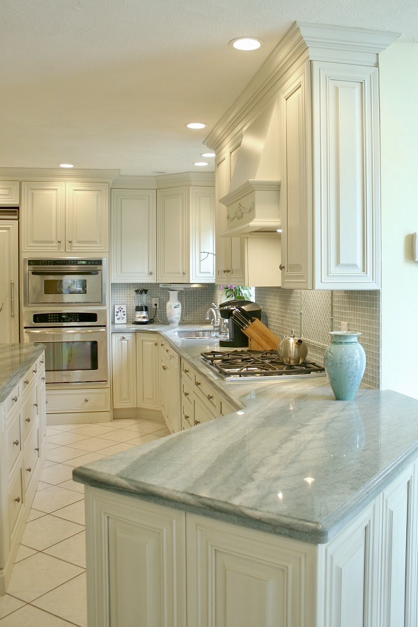 Grey-Blue countertops accent this clean white kitchen.