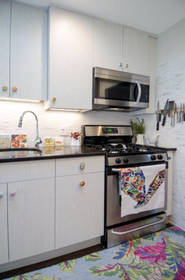 A kitchen with a stove and a refrigerator
