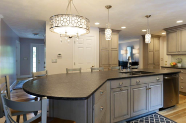 This elegantly designed kitchen features an island that seats up to 6 guests! Hanging lights brighten up this space while creating a sophisticated touch.