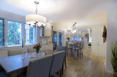 This gorgeous white kitchen features floor-to-ceiling cabinets, a wine rack and a peninsula that seats 3.