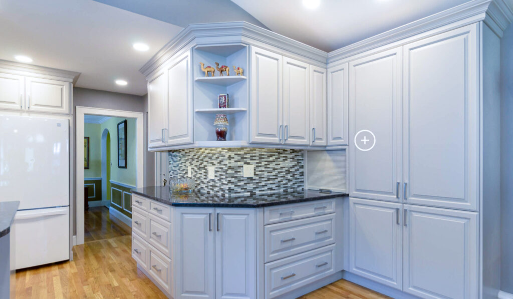 This uniquely shaped kitchen features both shaker cabinets and open shelves.