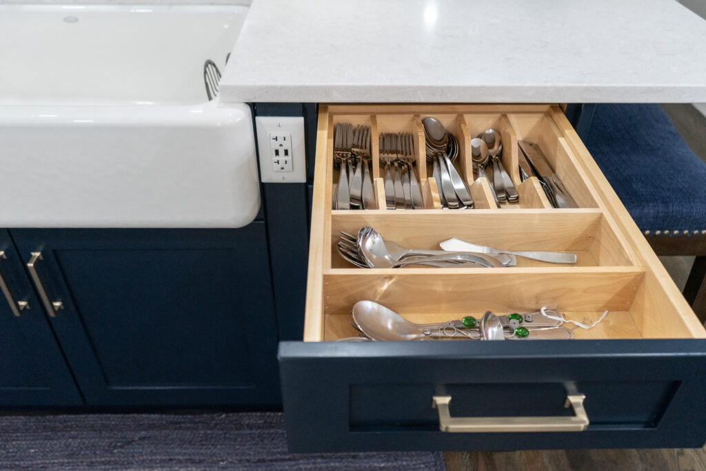 A kitchen island can be more than just extra storage. Electrical outlets, a farmers sink and seating make this island multi-functional.